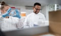 A man and a woman in white coats in a medical lab