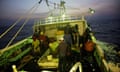 Men on a fishing boat at sea at night