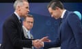Liberal leader and prime minister Mark Carney, left, shakes hands with Conservative rival Pierre Poilievre following the French-language federal leaders' debate, in Montreal, with Yves-François Blanche of the separatist Bloc Québécois in the background.