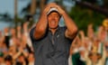 Rory McIlroy celebrates on the 18th green after winning the first playoff hole