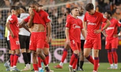 Sevilla’s players show their dismay after losing at Valencia on Friday – their fourth straight loss