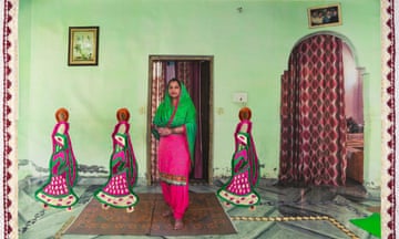 A middle-aged Indian woman in salwar kamise poses in a hallway with three smaller embroidered figures of women stitched into the photograph