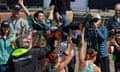 The Cambridge women’s Boat Race crew carry their cox, Jack Nicholas, aloft after their win