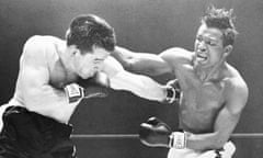 Middleweight champion Sugar Ray Robinson, right, throws a right over the head of Rocky Graziano during their 1952 fight.