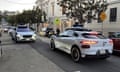 Two Waymo taxis meet in San Francisco.