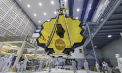 Technicians lift the mirror of the James Webb Space Telescope using a crane at the Goddard Space Flight Center