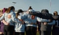 Female rugby players wearing The Good, The Scaz and The Rugby/Vodafone hoodies in a huddle