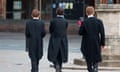 Three public school boys wearing tails, with their backs toward the camera