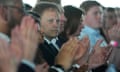 a man clapping in a crowd