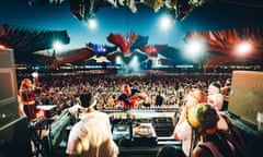 Looking out from behind the DJs' decks at the crowd under a night sky