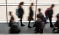 Secondary school pupils moving by a window in a school UK, blurred movement.