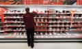 A Sainsbury's worker stacks shelves in a store