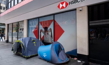 Two tents of people sleeping rough are set up on the pavement outside a branch of the bank HSBC
