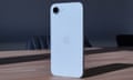 Apple iPhone 16e in white stood up showing the back glass.