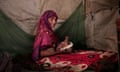 In this Feb. 9, 2018 photo, a Displaced woman holds her baby at a camp, Abyan, Yemen. (AP Photo/Nariman El-Mofty)