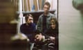 the four members of Model/Actriz standing in what looks like the studio of a picture framer