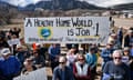 people hold a sign that reads 'a healthy home world is job #1 nothing works without it there is no planet b'