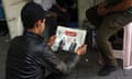 Back view of man with newspaper