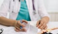 A doctor writes a prescription.