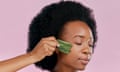 A woman uses a jade gua sha