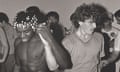 Monochrome photograph of two young men, one black and one white, dancing