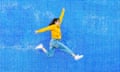 Woman jumping in front of a blue background