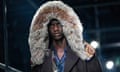 A model wears a a coat with large faux-fur hood